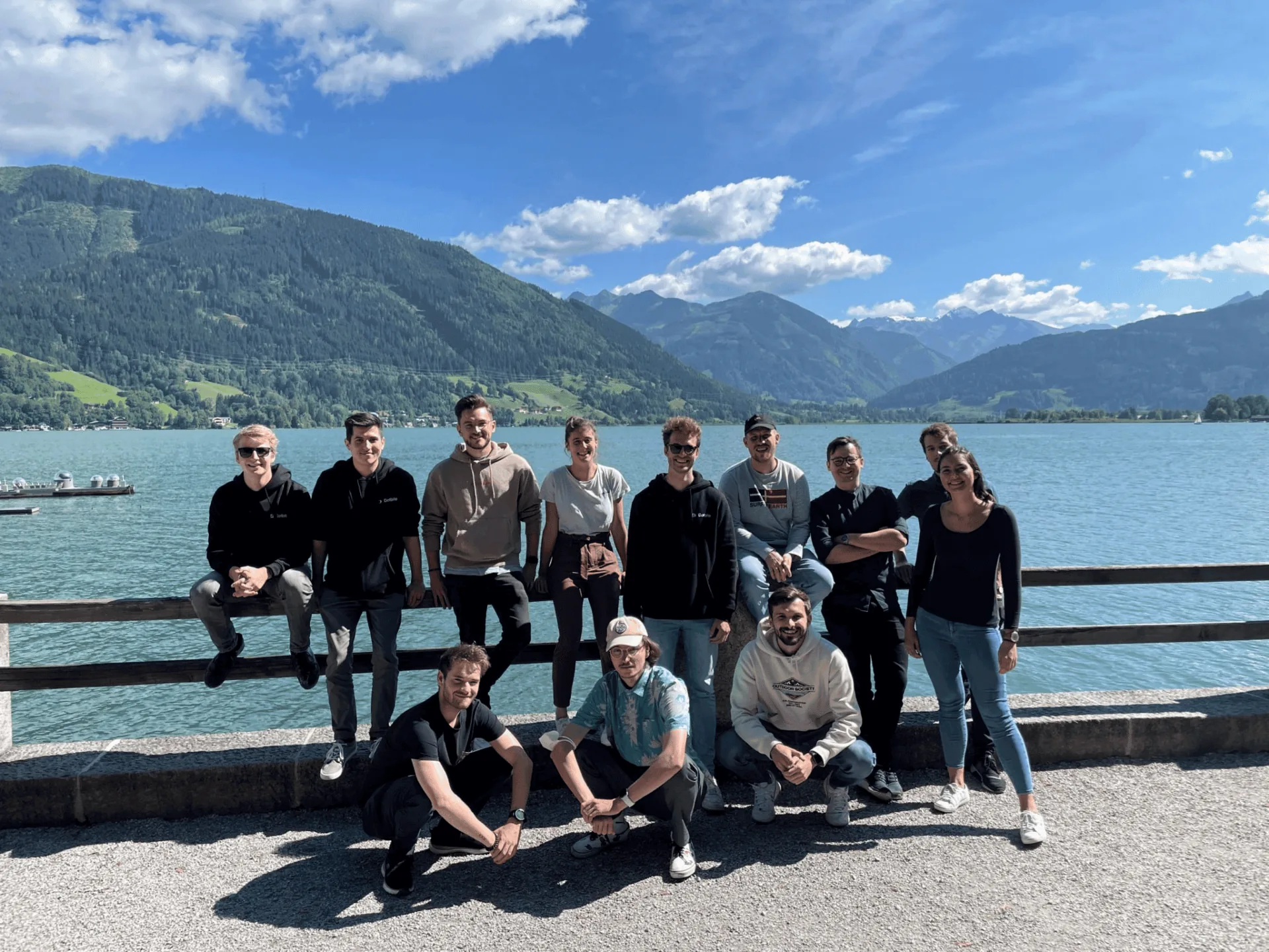 Dotbite team standing in front of a lake