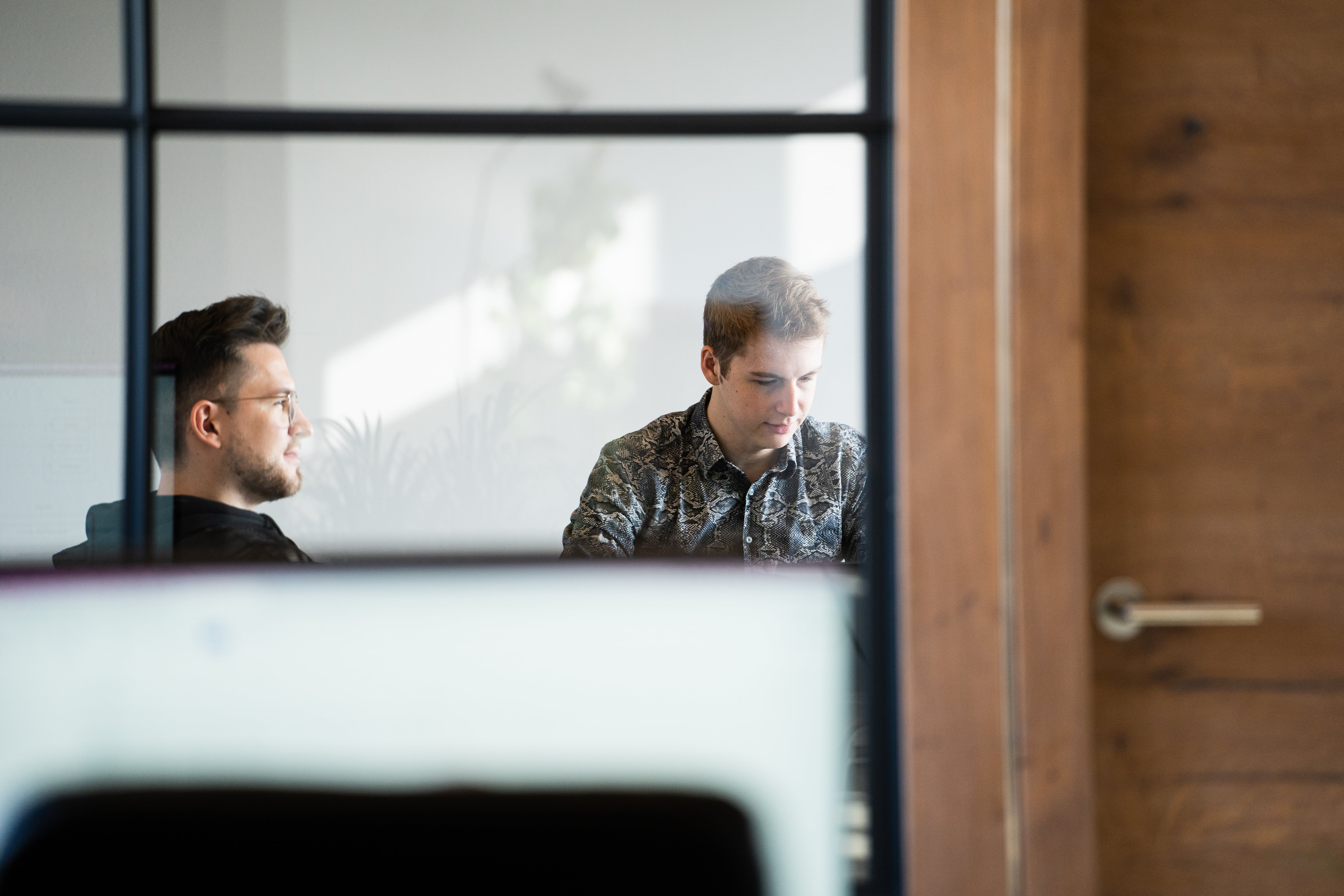 Sales Manager and Developer sitting in the meeting room Sales Manager and Developer sitting in the meeting room