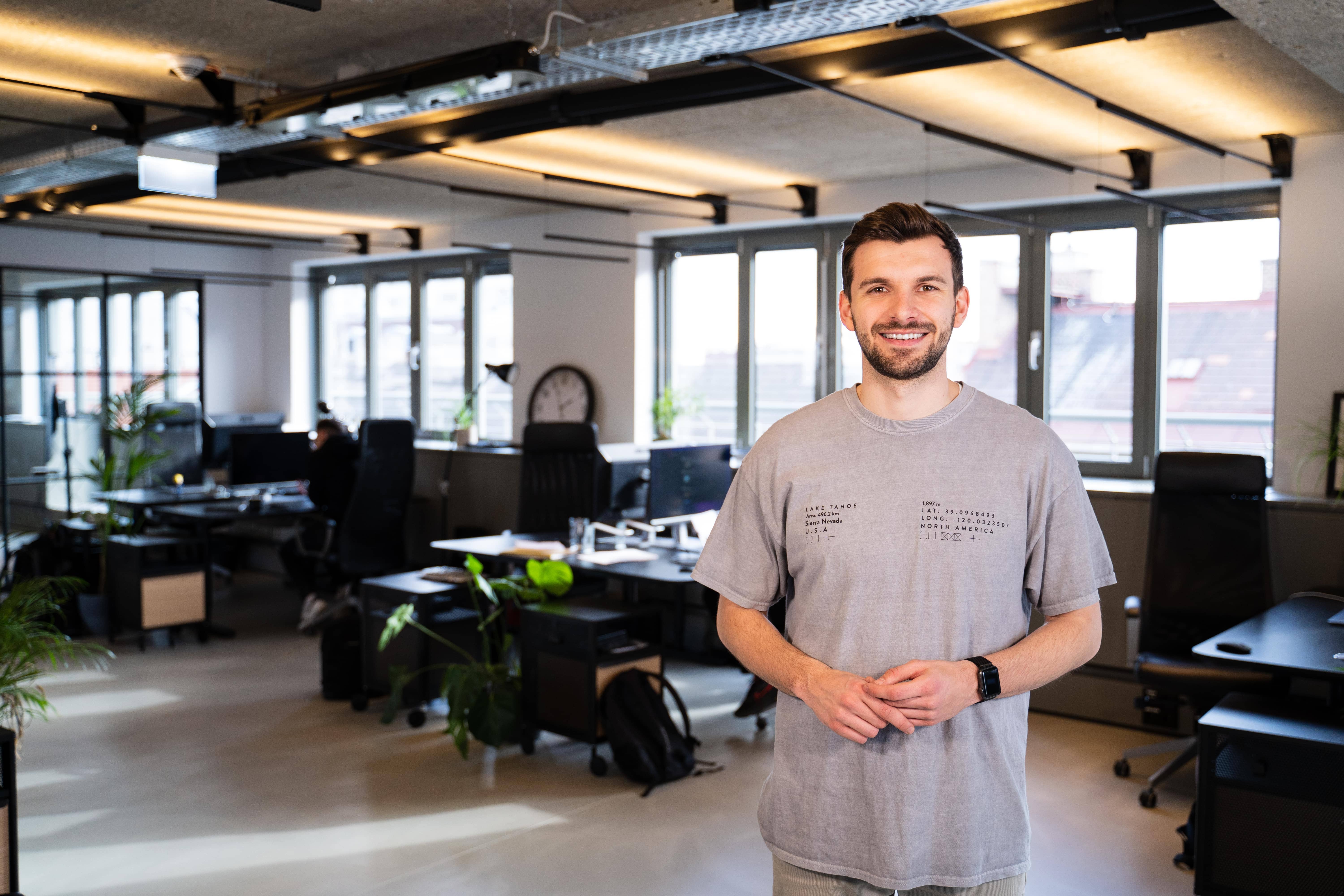 Co-Founder Emir standing in the middle of the office Co-Founder Emir standing in the middle of the office
