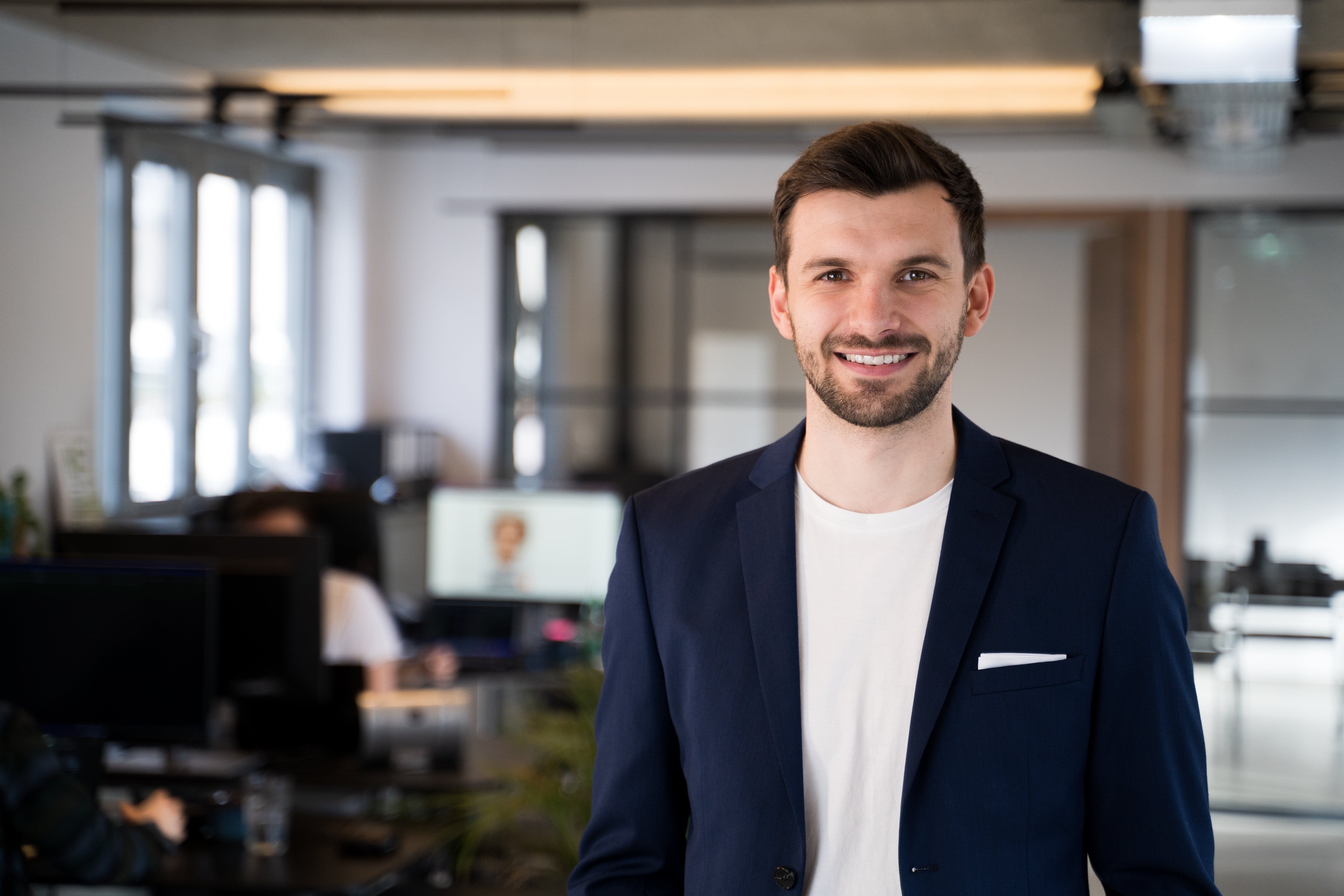 Co-Founder Emir stands in the office