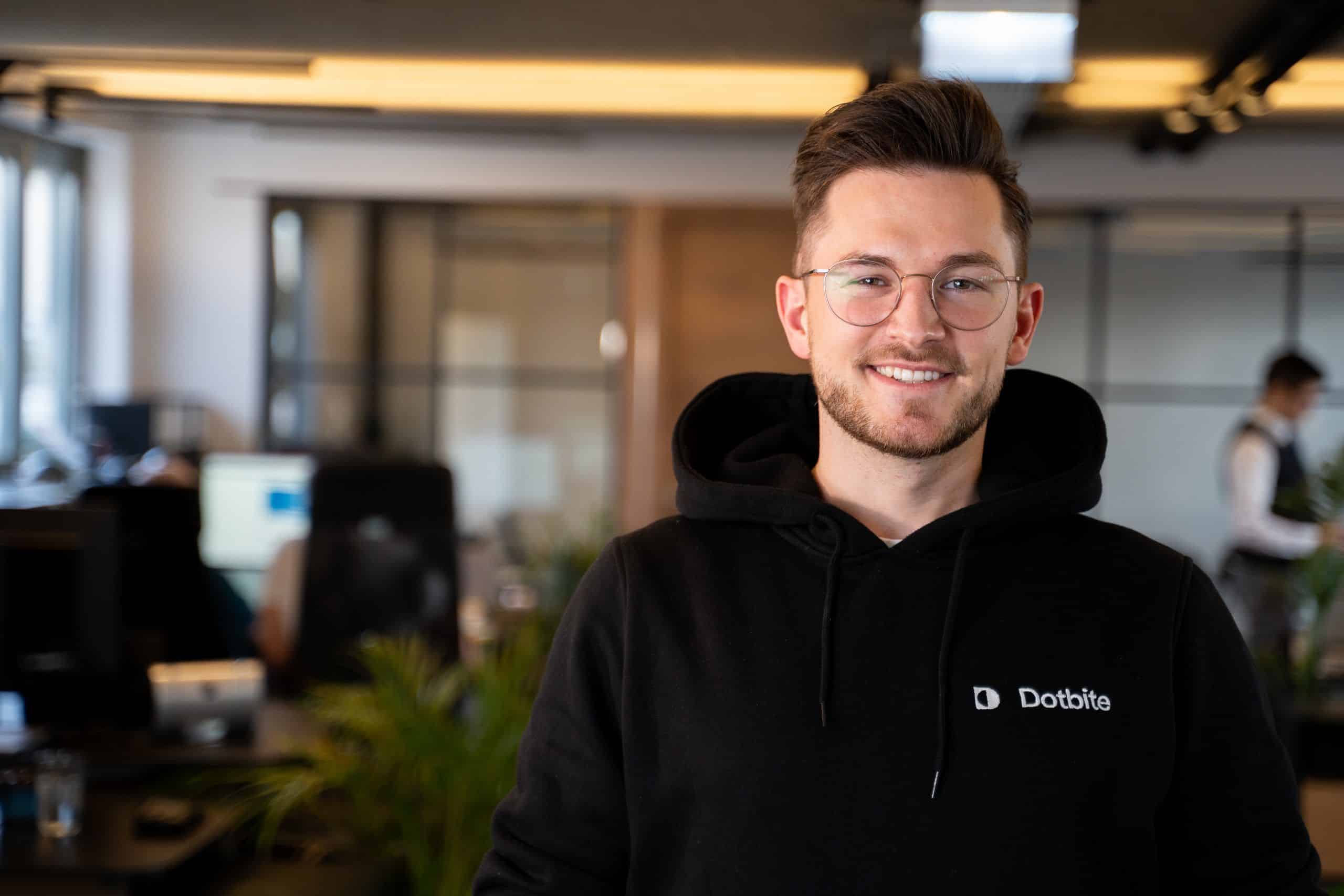 Sales Manager smiles and stands in front of the meeting room